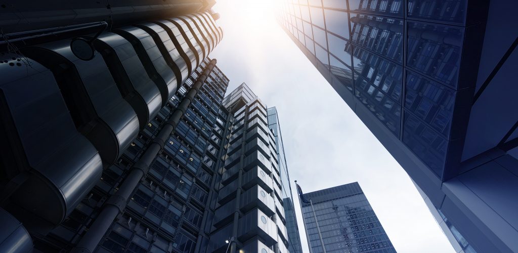 low angle shot of futuristic glass and steel office towers in London financial district, London, Great Britain